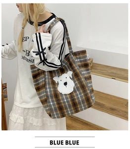 Close-up of retro plaid tote bag featuring a cute plush puppy patch and long shoulder strap