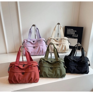 Detailed view of large capacity waterproof nylon travel bags in five assorted colors