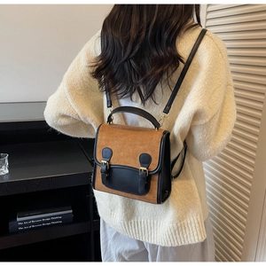 Retro contrast small backpack on model wearing cozy cream sweater in a vintage library setting