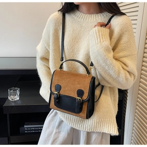 Detail view of vintage frosted backpack with brown suede and black leather accents