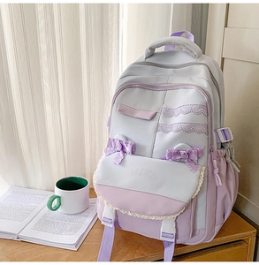 Close-up of light purple school backpack with lace trim and satin bow decoration