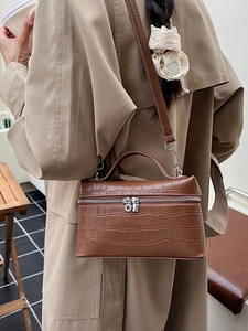 Brown crocodile pattern rectangular handbag with silver zipper and adjustable crossbody strap