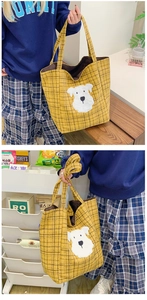 Detail view of yellow plaid tote bag with cute cartoon puppy patch and large capacity