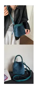 Detail of teal suede bucket bag featuring woven handle and adjustable shoulder strap