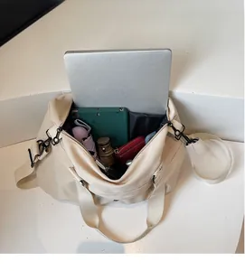 Detailed top view of a large beige canvas tote bag showing its spacious inner compartment