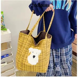 Close-up of yellow plaid tote bag with cute dog embroidery and sturdy double handles