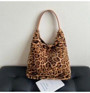 Detail of leopard print faux fur tote bag showing plush texture and brown leather handles