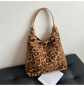 Detail of plush leopard print faux fur tote bag with brown faux leather handles