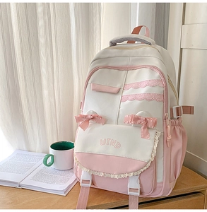 Detail view of sweet pink and white student backpack with lace trim and bow decorations