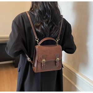 Detail of vintage brown frosted backpack showing adjustable straps and stylish texture