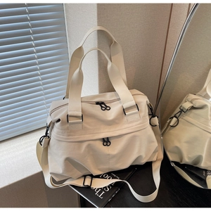 Detail of beige large canvas tote with adjustable strap on a minimalist black table