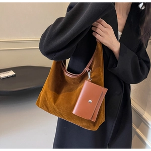 Caramel suede tote bag with leather pouch detail shown on black blazer model