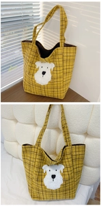 Detail of yellow checkered tote bag featuring a cute plush dog patch embroidery