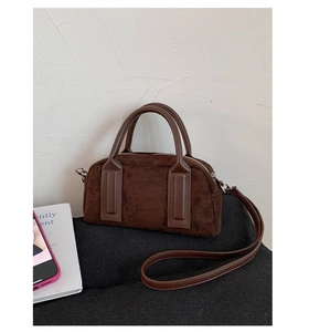 Detailed close-up showing the suede texture and sturdy stitching of the brown Boston bag