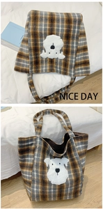 Close-up of vintage plaid tote bag with cute white schnauzer plush patch detail