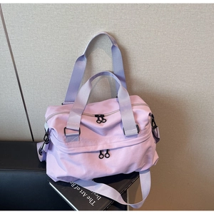 Detail view of water-resistant lavender nylon travel bag with adjustable shoulder strap