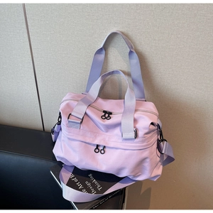 Detail view of a lavender multi-functional travel tote with side zippers and nylon texture