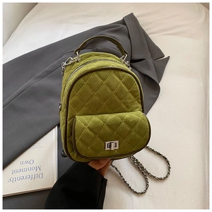 Detail of olive green quilted mini backpack featuring soft suede texture and silver chain strap