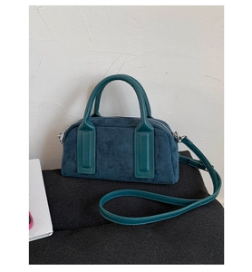 Detailed view of dark cyan faux suede boston bag with matching leather straps and metal zipper