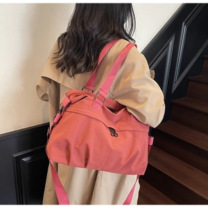 Detail view of coral pink canvas tote bag with textured ruffles and adjustable strap