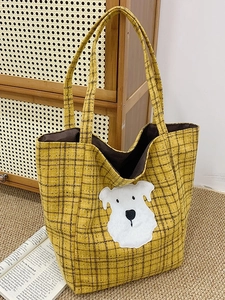 Retro yellow checkered tote bag featuring a cute plush puppy patch in a cozy setting