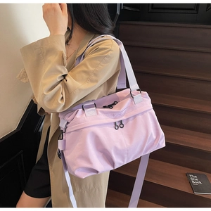 Close-up of light purple large canvas tote with adjustable strap and decorative zipper
