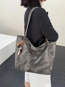 Elegant dark grey vintage tote bag with beaded charm accessory for women's daily commute