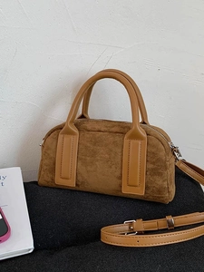 Brown suede-texture bowling bag with smooth handles and adjustable strap for women