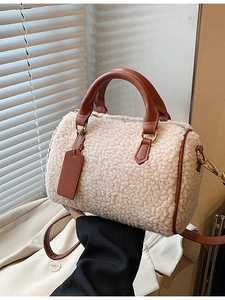 Chic plush faux shearling Boston bag with brown faux leather trim and gold zippers