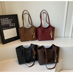Selection of chic tote bags in black, burgundy, tan, and dark coffee with beaded charms