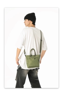 Green checkered tote bag shown on model with adjustable black crossbody strap detail