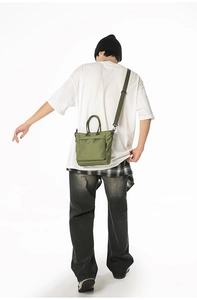 Dark green checkered tote bag shown on model highlighting large capacity and daily style