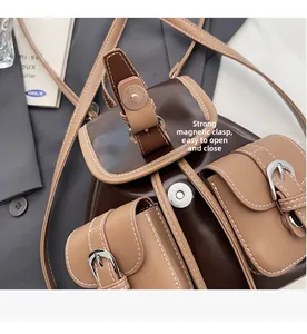 Detail shot of the convenient magnetic snap closure on the vintage brown backpack