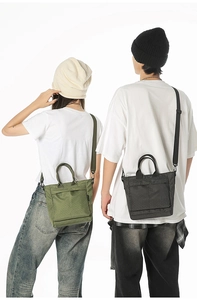 Macro detail of the grid texture on green and black nylon tote bags worn by models