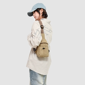 Close-up of khaki crossbody bag featuring drawstring closure and nylon fabric texture
