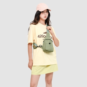 Close-up of green water-resistant nylon crossbody bag with drawstring pocket and buckle