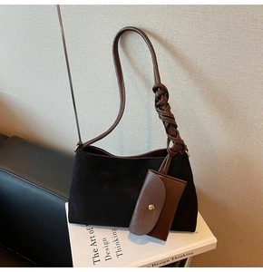 Detail of suede shoulder bag with brown braided leather strap and matching mini card pouch