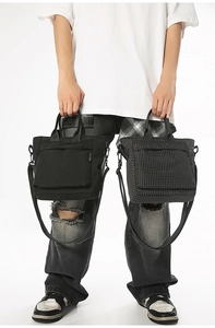 Detail of classic black and checkered tote bags with reinforced handles and shoulder straps