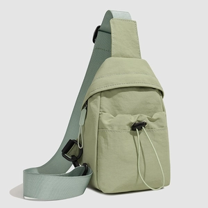 Detail of lime green crossbody bag showing nylon fabric texture and adjustable strap