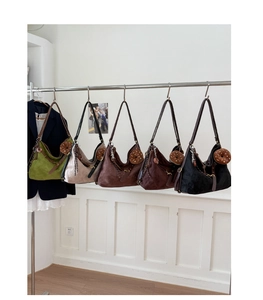 Detail view of stylish hobo bags in five colors featuring unique donut charms