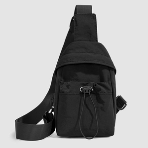 Close-up of black nylon sling bag featuring adjustable strap and elastic drawstring pocket
