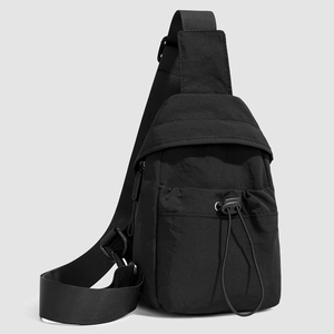 Detail of waterproof nylon crossbody bag featuring adjustable strap and drawstring pocket