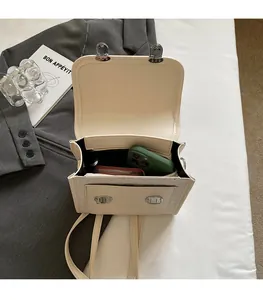 Interior view of off-white faux leather backpack showing space for phone and wallet