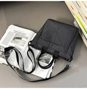 Black and white checkered tote bag with adjustable strap and design magazine layout
