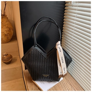 Detail of black woven leather shoulder bag with V-cut top and silk scarf handle