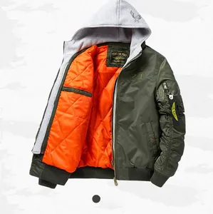 Close-up of olive bomber jacket with orange quilted lining and tactical sleeve pocket