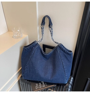 Close-up of the vintage dark blue denim tote bag with silver chain woven shoulder strap