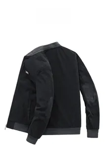 Detail view of black corduroy jacket showing ribbed cuffs and elbow patch on white background