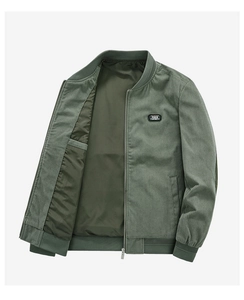 Detail of dark green corduroy jacket showing rib-knit collar and FREE SPIRIT patch