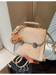 Chic beige leather backpack for women with plush bear charm and adjustable straps